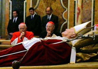 In this picture made available by the Italian Presidency, Cardinal Miloslav Vlk of the Czech Republic, left, and Cardinal Francesco Marchisano of Italy mourn Pope John Paul II, lying out in state in the Clementine Hall at the Vatican, Sunday, April 3, 2005. The Pope died on Saturday at the Vatican after a 26-year pontificate. He was 84. (AP Photo/Italian Presidency, Enrico Oliverio)